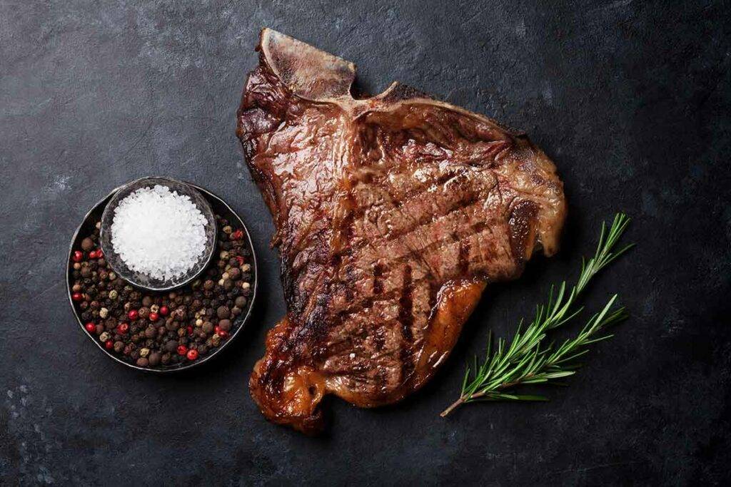 Greek-Seasoned T-Bone Steaks with Cucumber and Tomato Salad