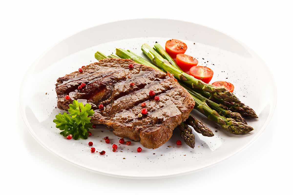 ribeye steaks with sautéed grape tomatoes and brie