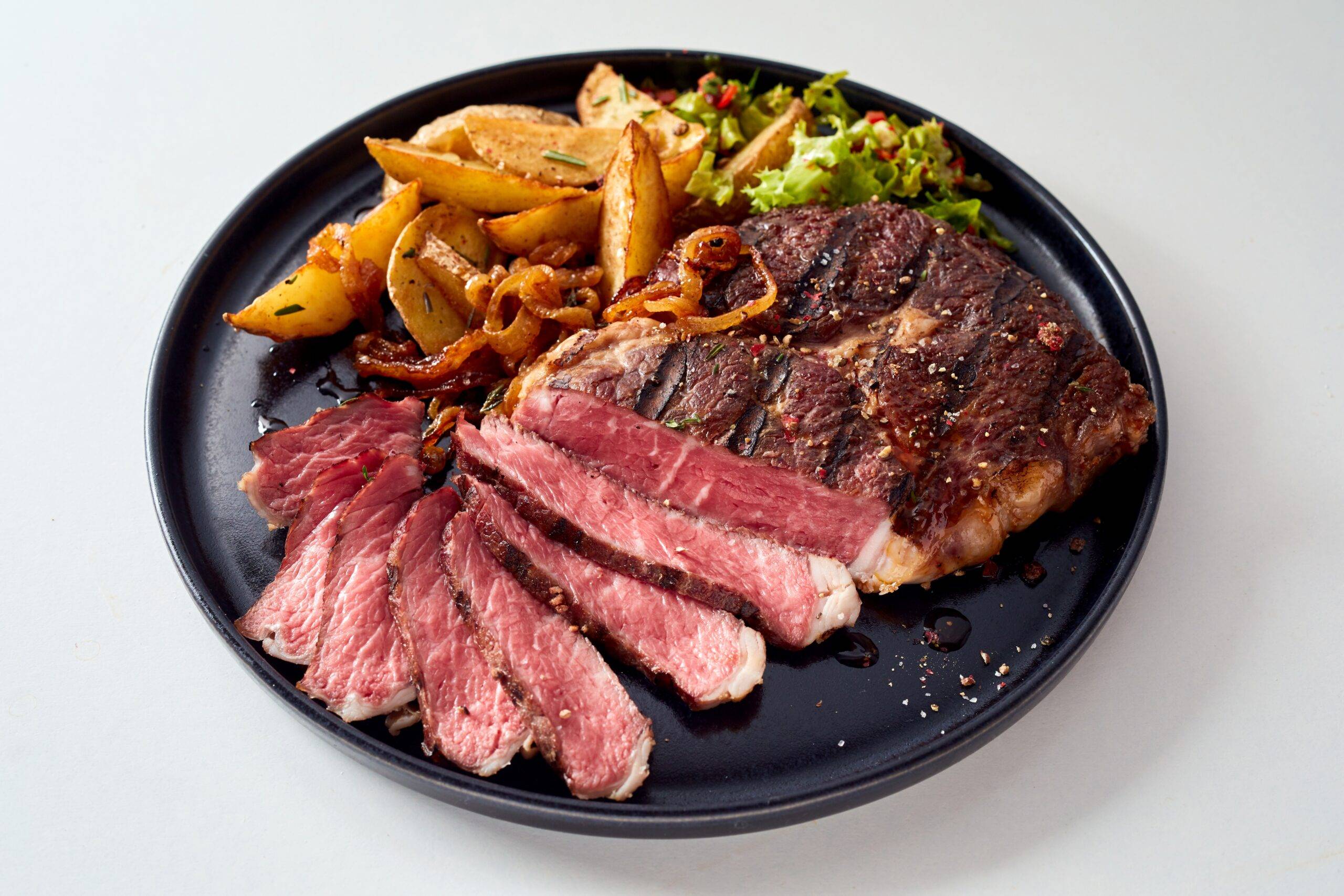 High-Angle-Of-Palatable-Grilled-Beef-Steak-And-Potatoes-Wedges high angle of palatable grilled beef steak and potatoes wedges
