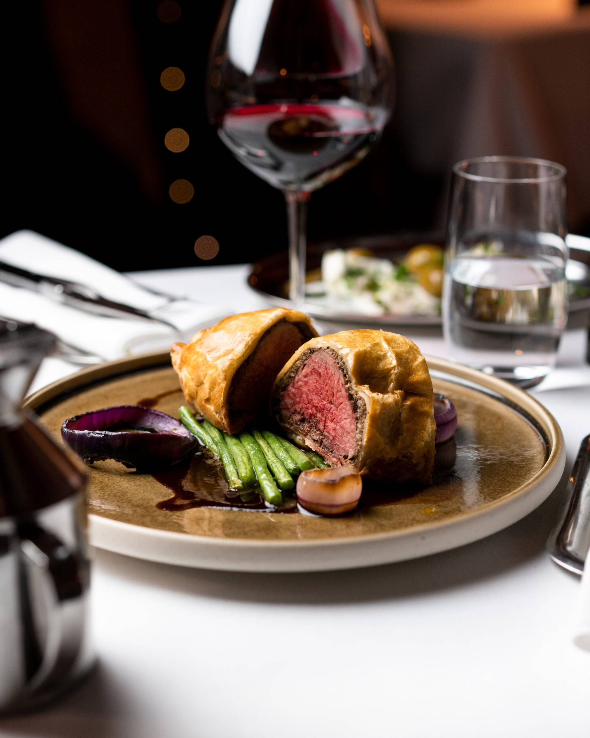 Beef-Wellington-With-A-Glass-Of-Red-Wine beef wellington with a glass of red wine
